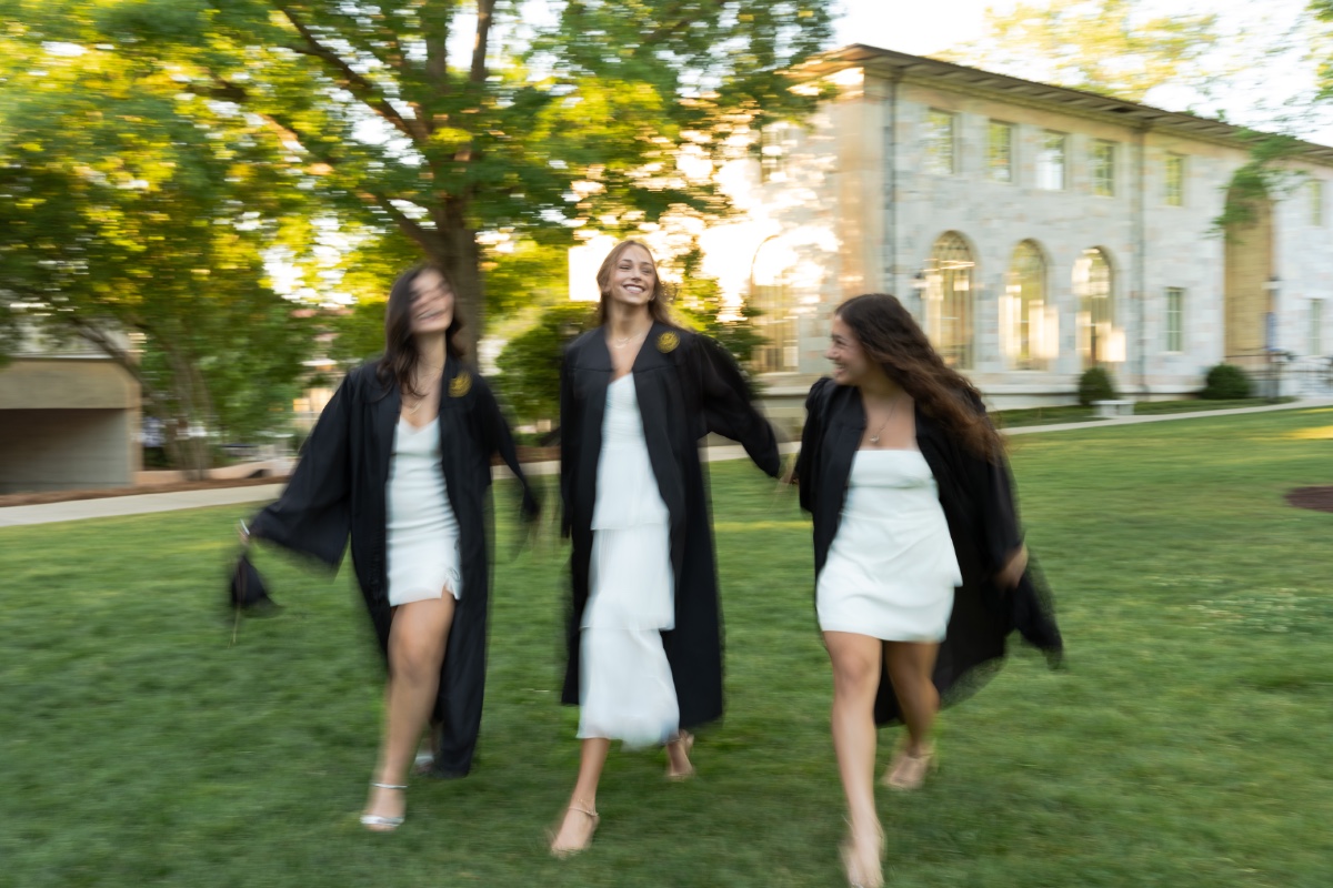 Three grads walking the Emory quad